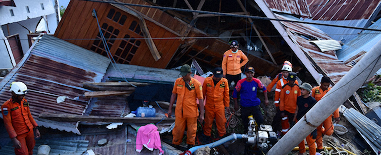 rescue workers combing through the rubble after the Indonesian earthquake and tsunami