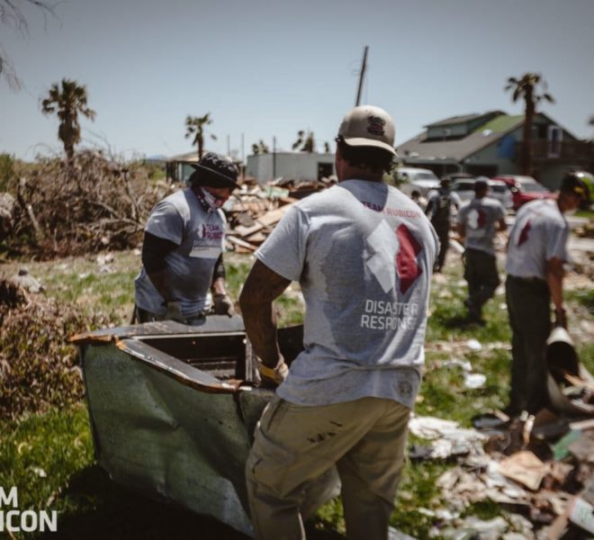 Volunteers removing debris in the tropical heat